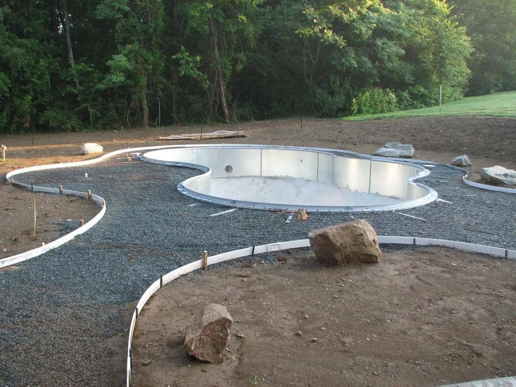 Inground pool shell being installed