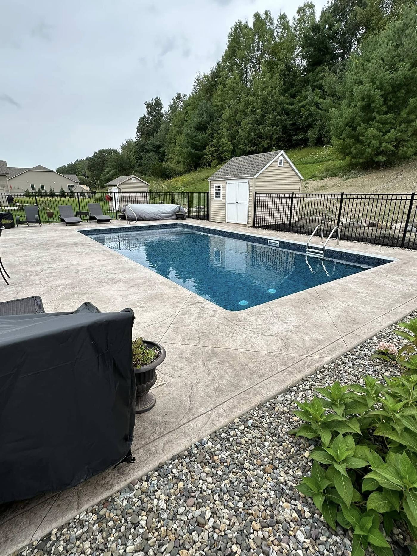 Fiberglass inground pool with stamped concrete patio